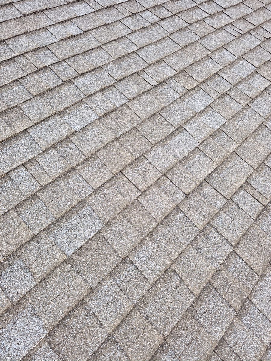Cracked composition shingles with exposed nail pops on an aging residential roof in Atwater CA — diagnostic photo by Econo Roofing showing fastener back-out from thermal cycling.