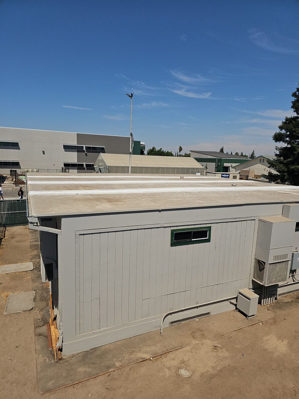 Completed white TPO roof on a Manteca High School portable classroom building