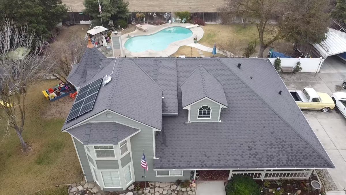 Los Banos home with rooftop solar panels on a new Econo roof