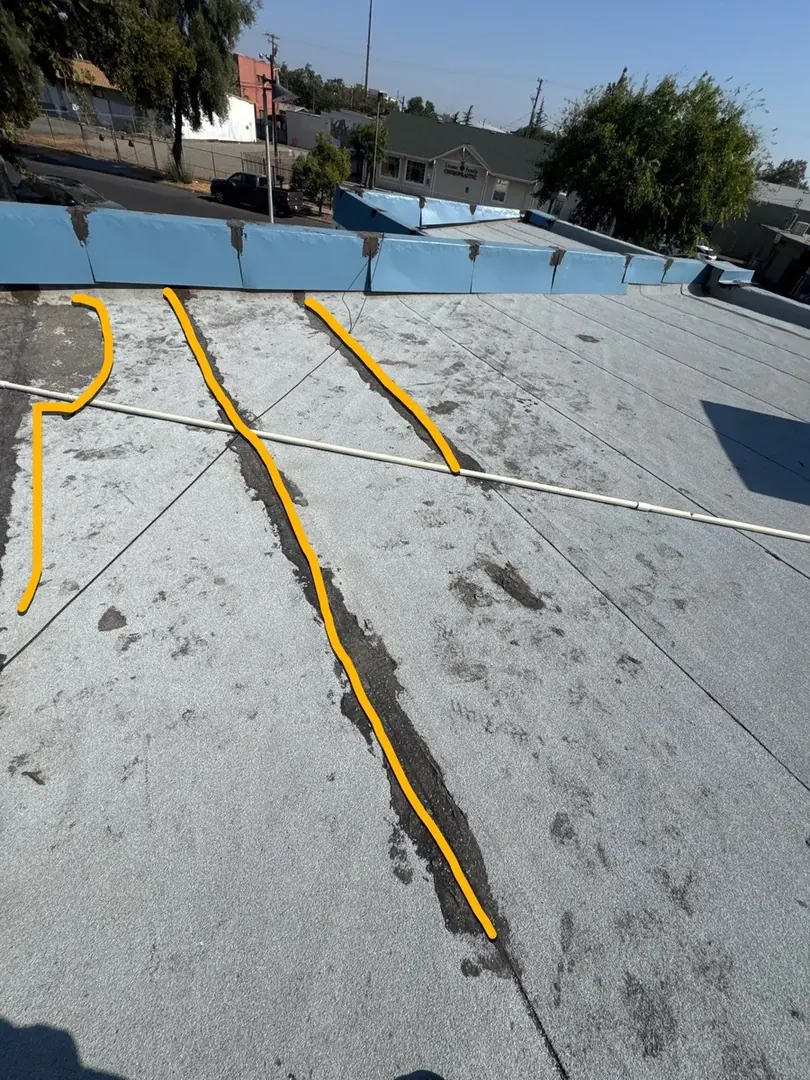 Beto's Bakery in Modesto before flat-roof coating — weathered commercial roof