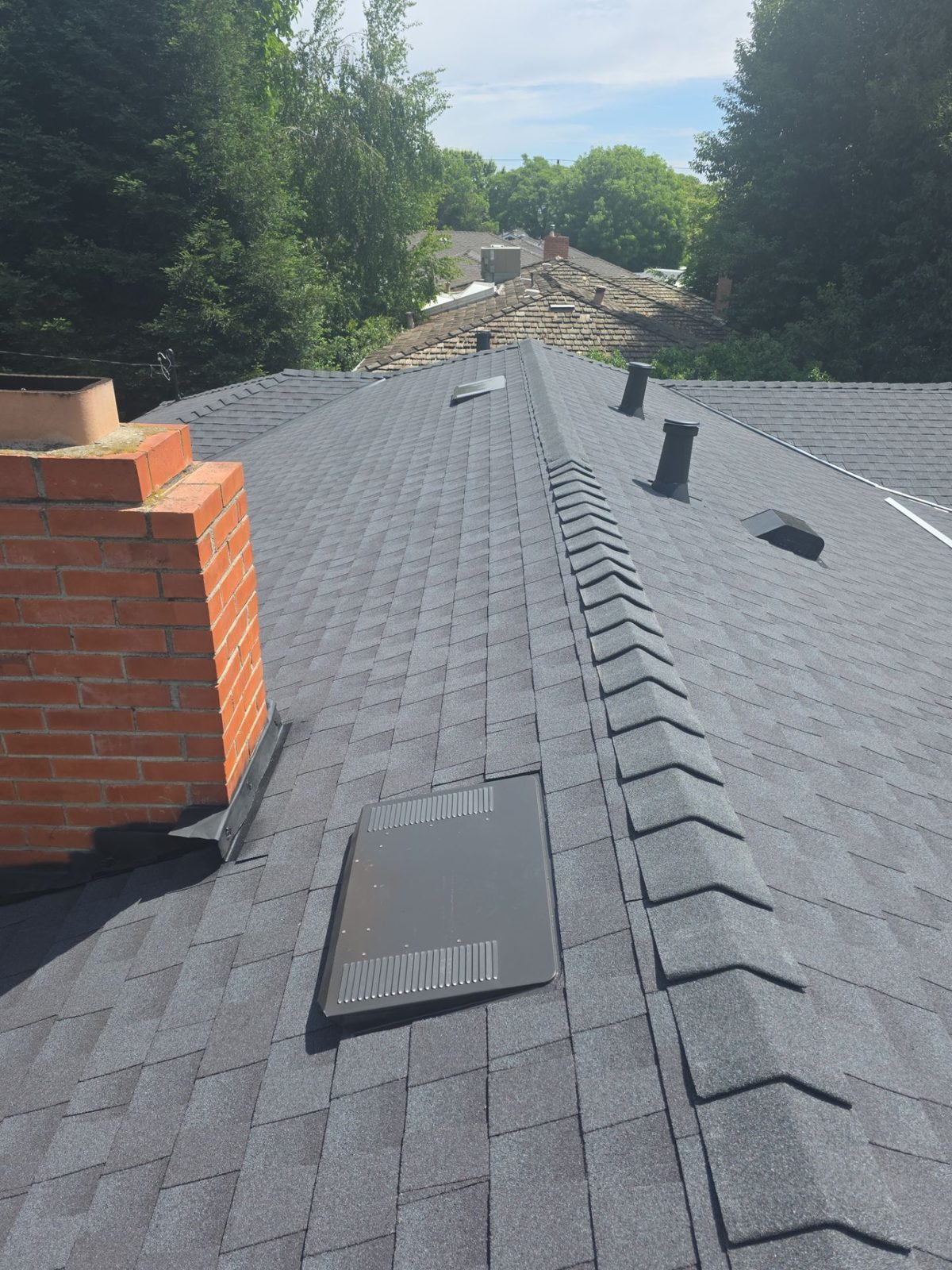 New shingles and chimney flashing detail after Econo install
