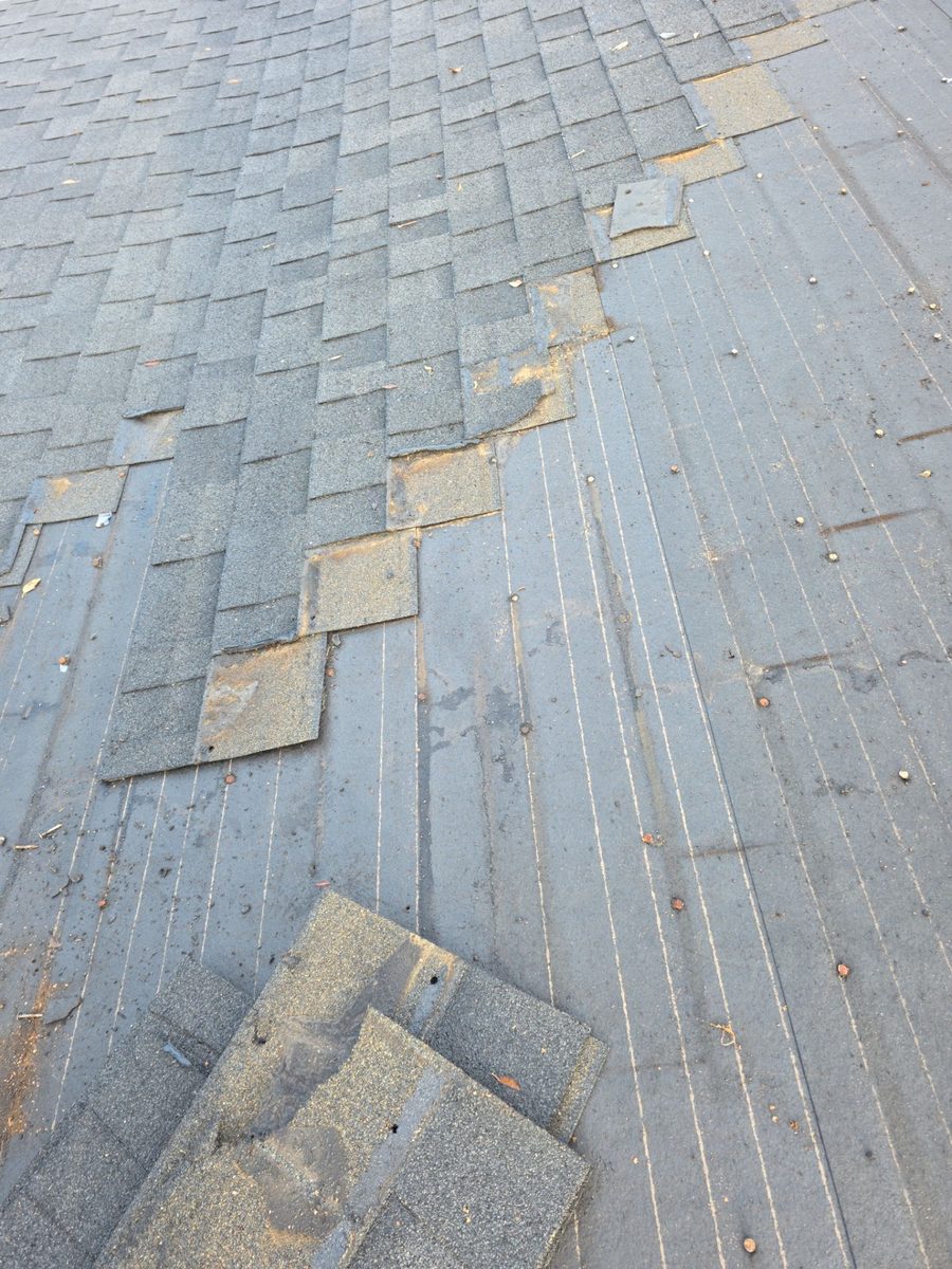 Active roof tear-off in progress on an Econo emergency job